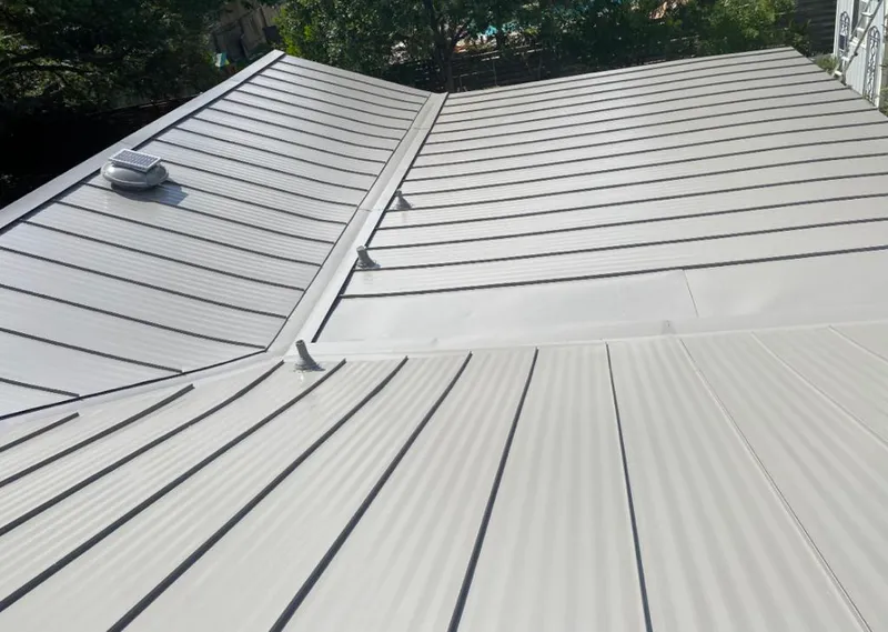 Solar attic fan installed on a metal roof for Roof Ventilation in Springville